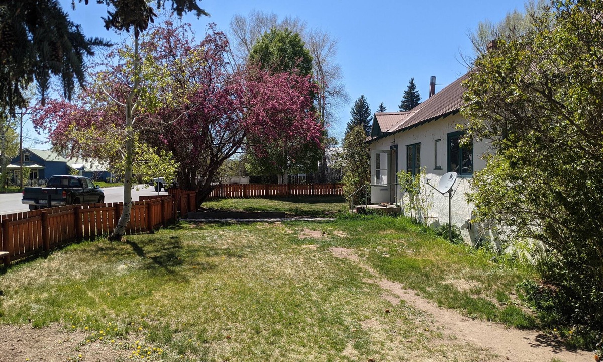 Gunnison House | Cheerful 3 bedroom in convenient location with a hot tub, sunroom and big yard.