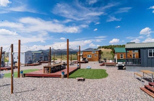 Meeker House | Our newest and one of our largest tiny homes contains a queen bed on the main level and two queen lofted beds. Sleeps: 6