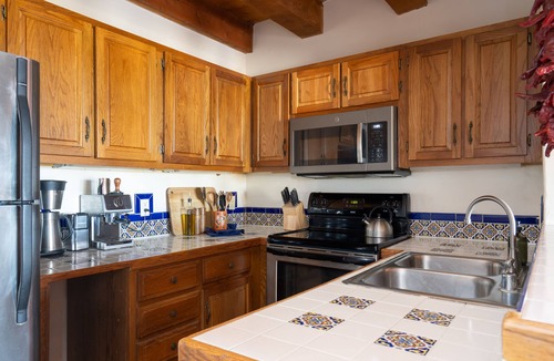 Arroyo Seco Apartment | Queen adobe studio with full kitchen, in-unit washer/dryer & fireplace. Private balcony + valley views. 15 min to Taos Ski Valley · 5 to Arroyo Seco. Sleeps 2.