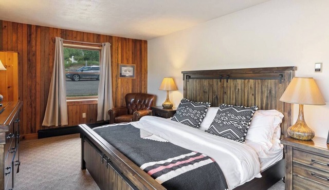 Spacious private king suite in the True North Adventure Lodge. Includes a king bed, private ensuite bathroom, and access to shared lodge amenities like the kitchen, great room, and hot tub. Ideal for couples or guests wanting extra space.